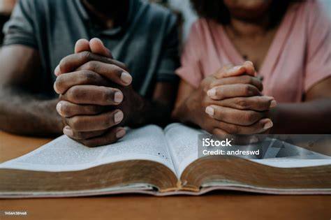 Couple praying together on anniversary